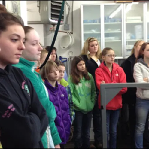 Kids in 4-H riding club listening to veterinarian
